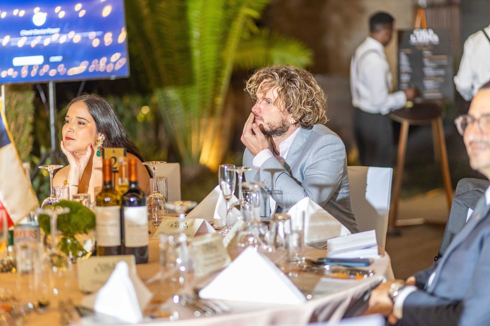 Two guests listening during dinner