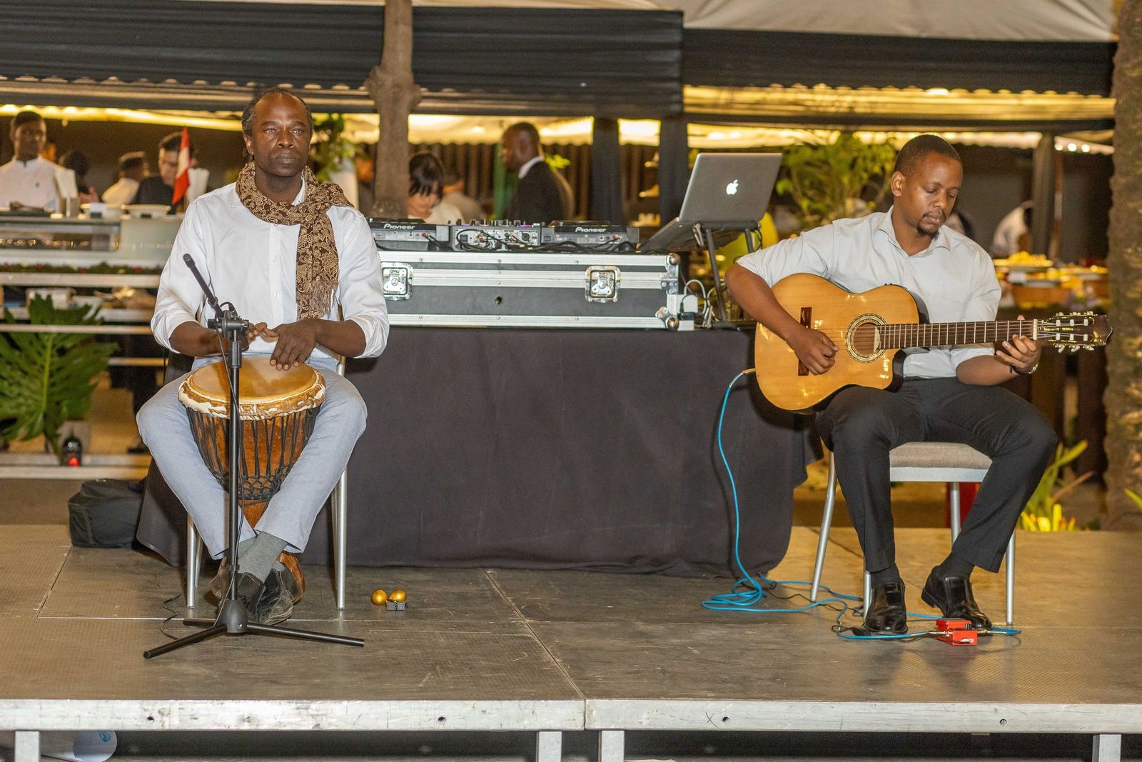 A drummer and a guitarist performing on stage