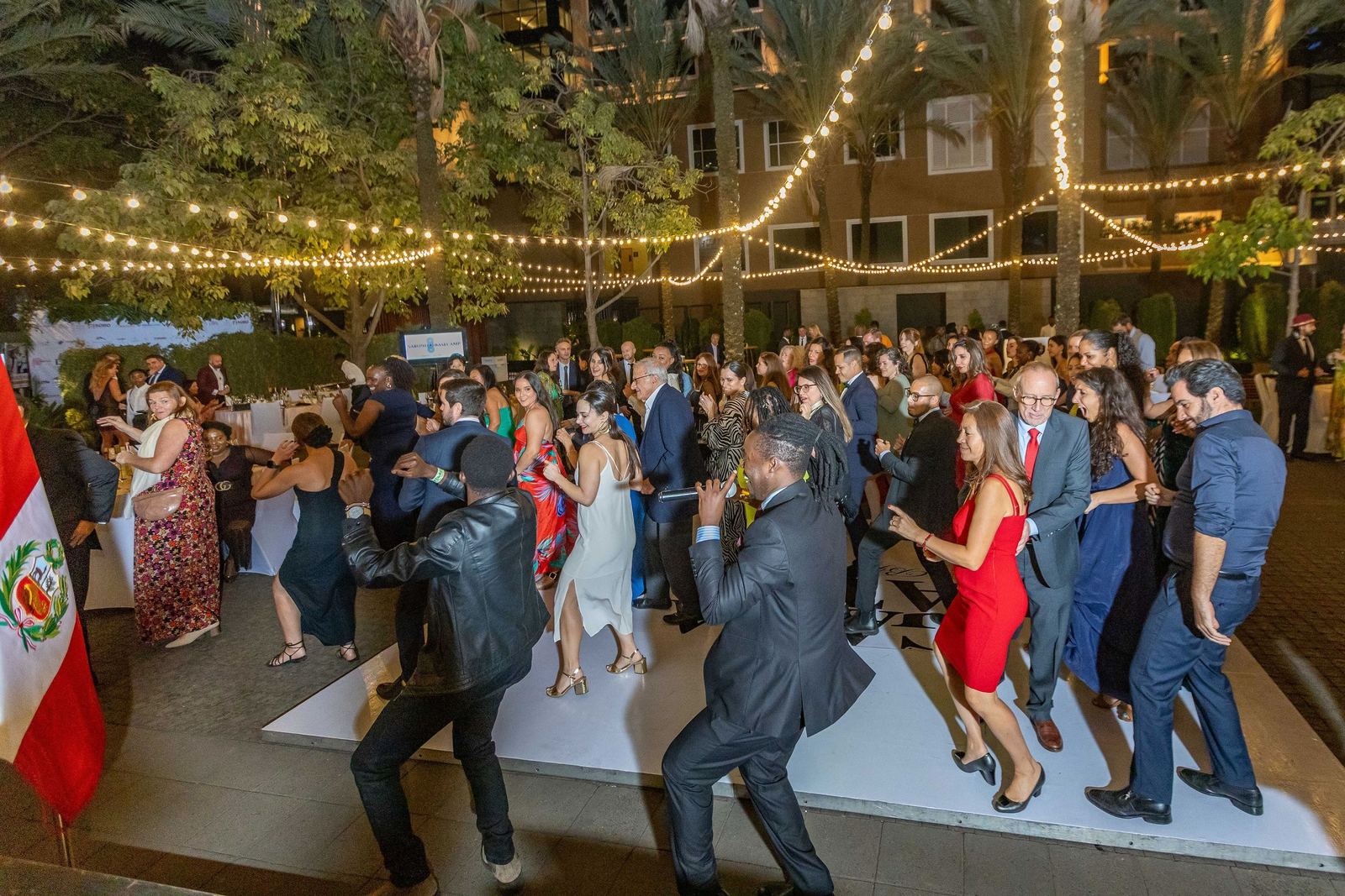 Guests dancing under string lights