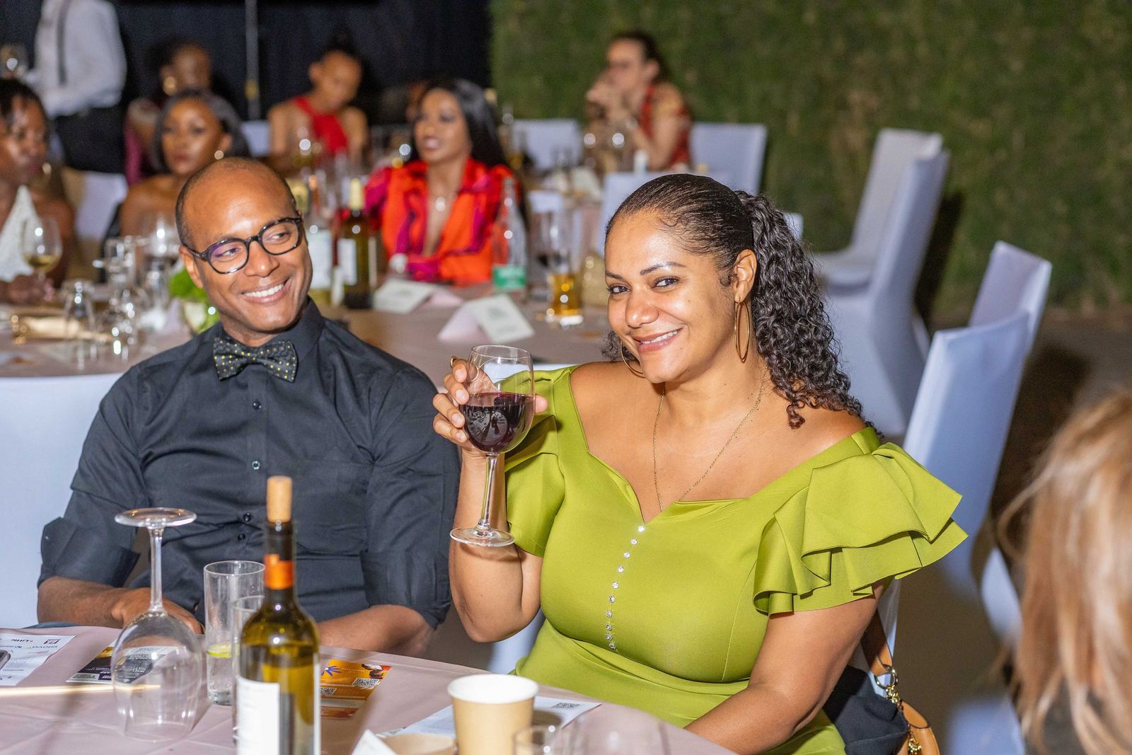 Guests raising a glass at dinner