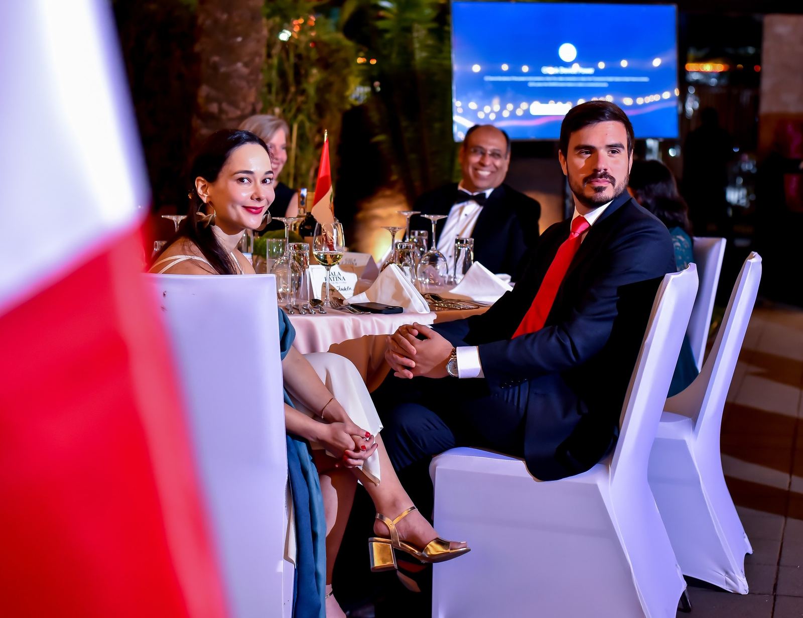 Guests seated at a table in evening wear