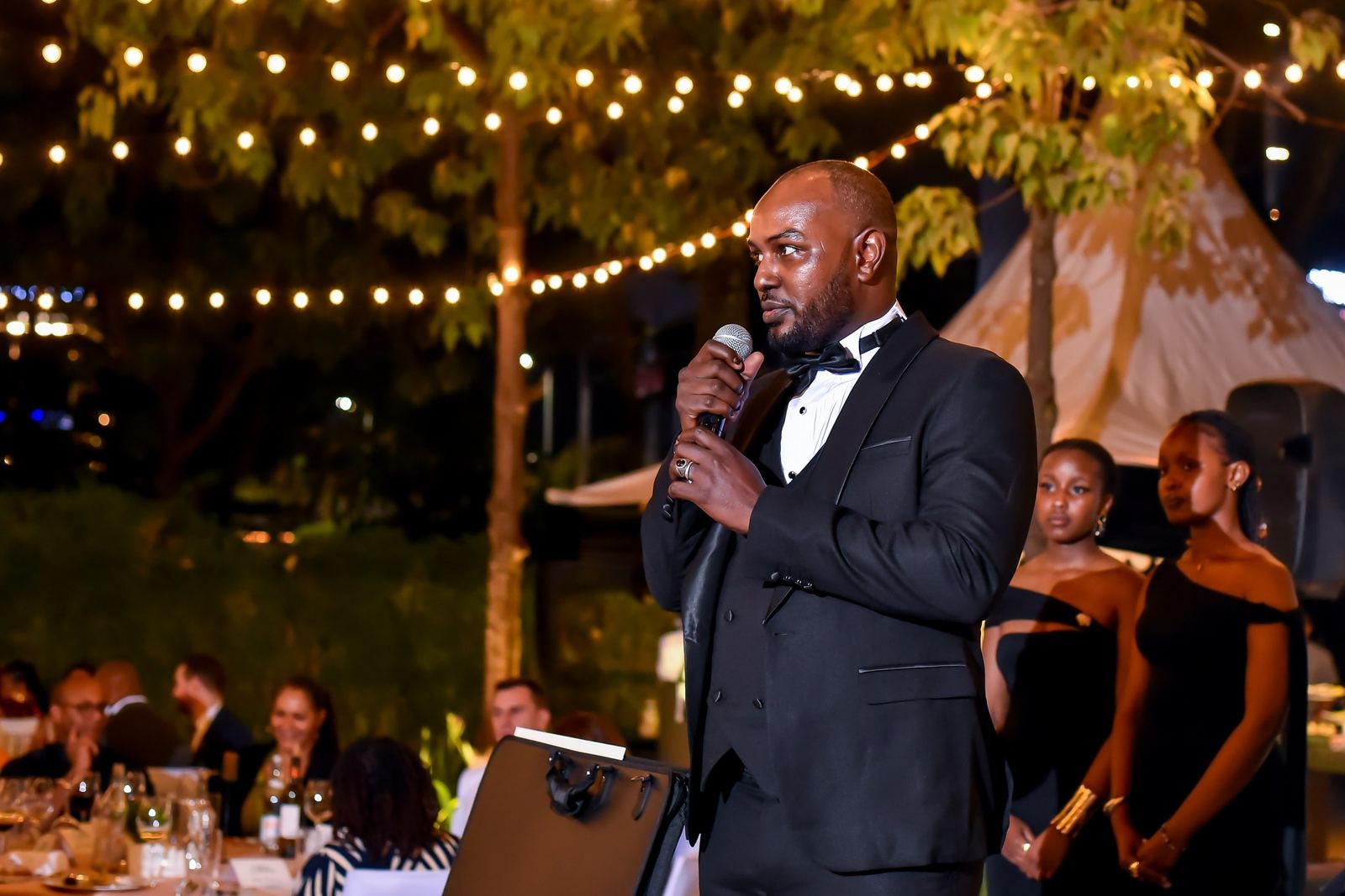 The master of ceremonies speaking under the lights
